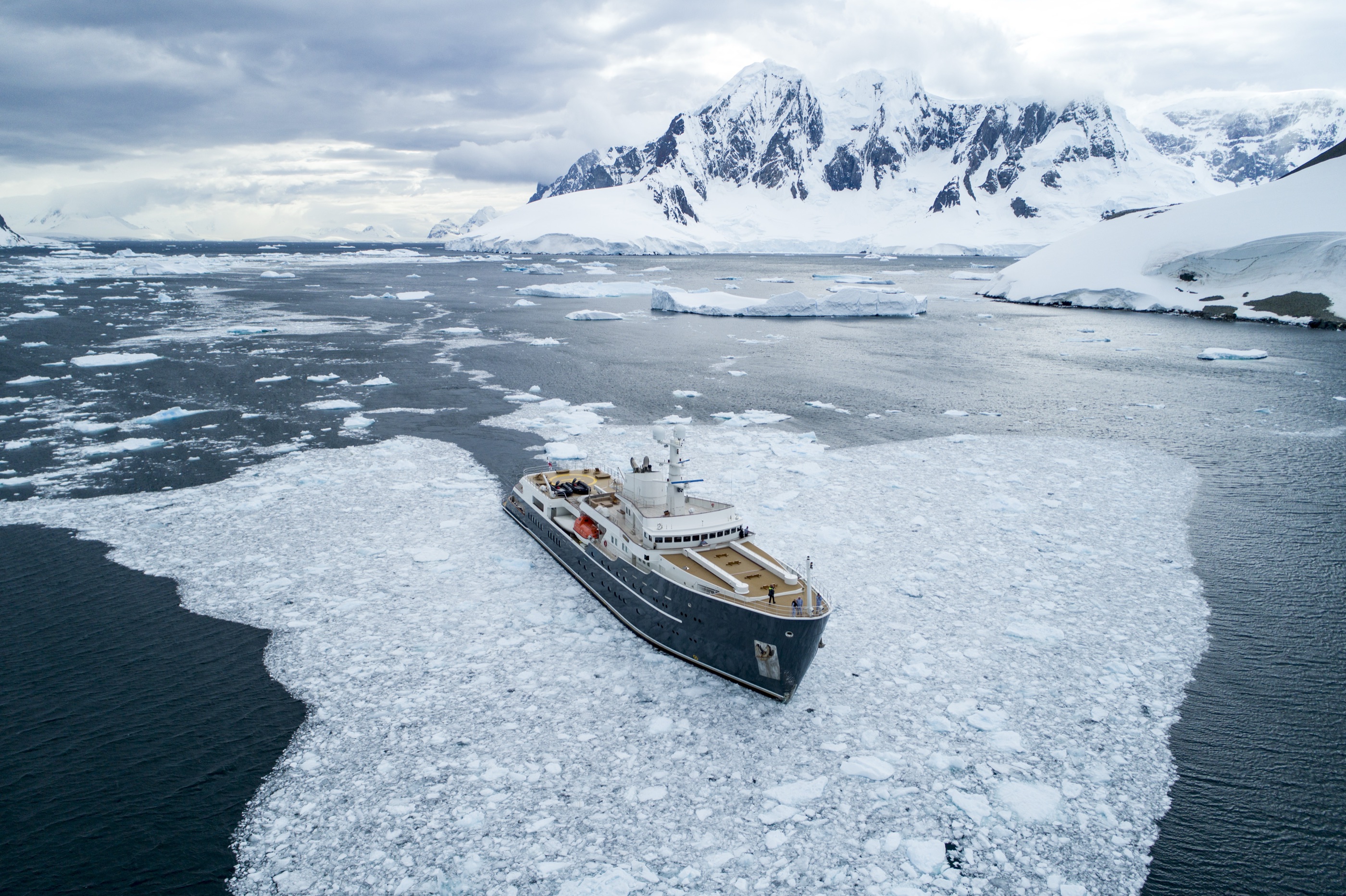 Explorer yacht navigating a lead through pack ice