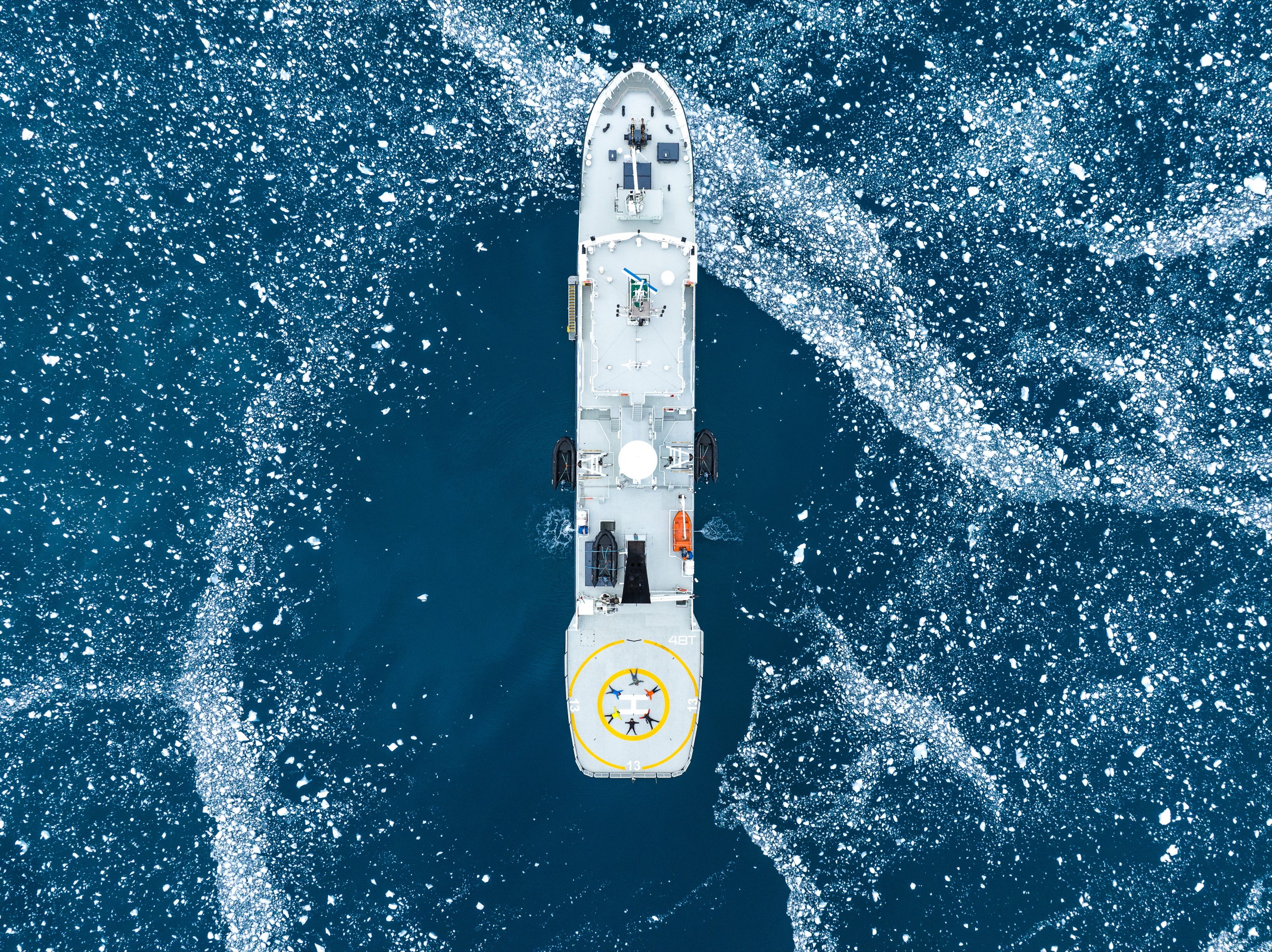 Top-down of an explorer yacht with aft helideck in ice