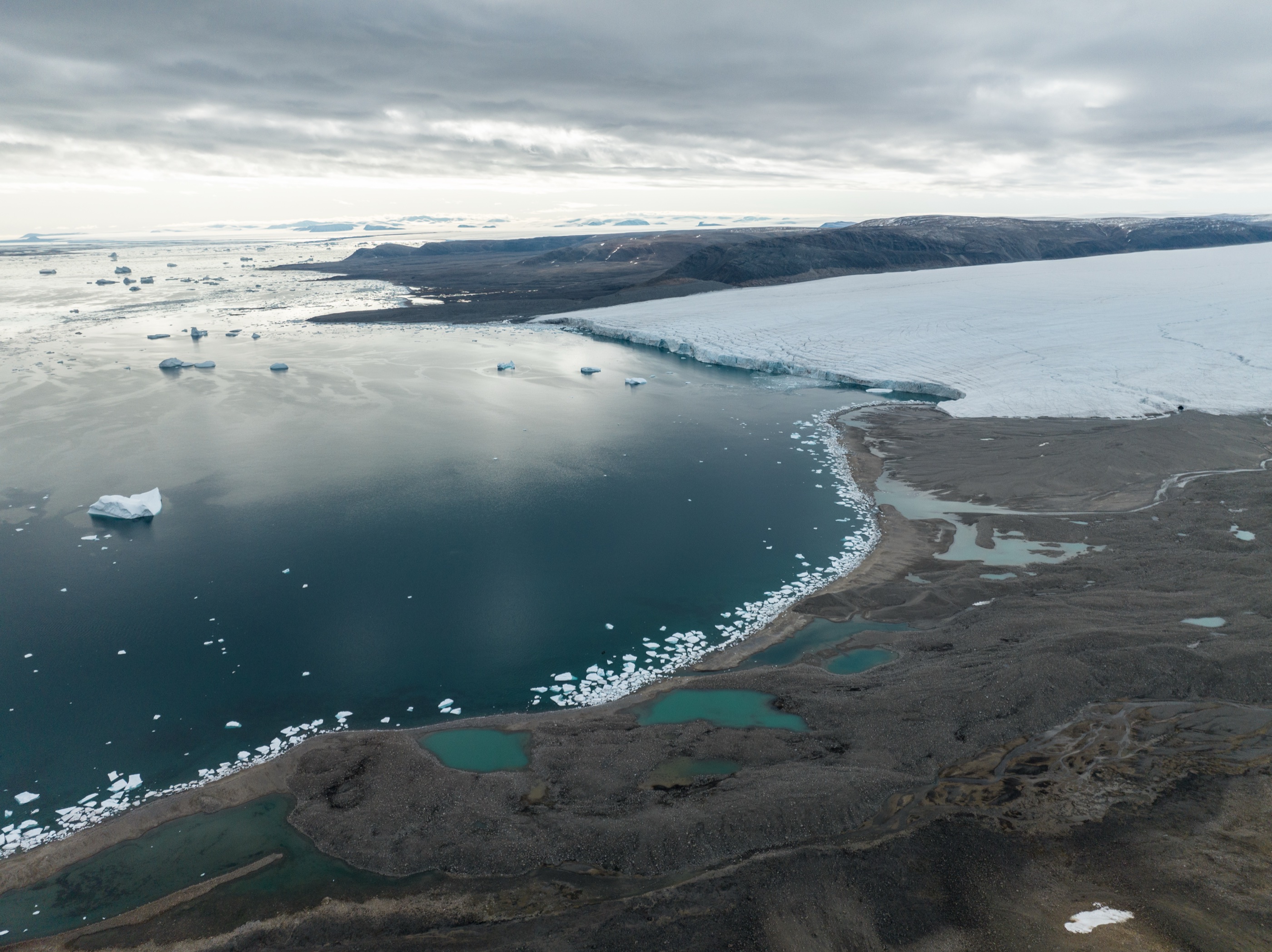 Aerial of Philpots Island coastline with ice and meltwater, Canadian Arctic